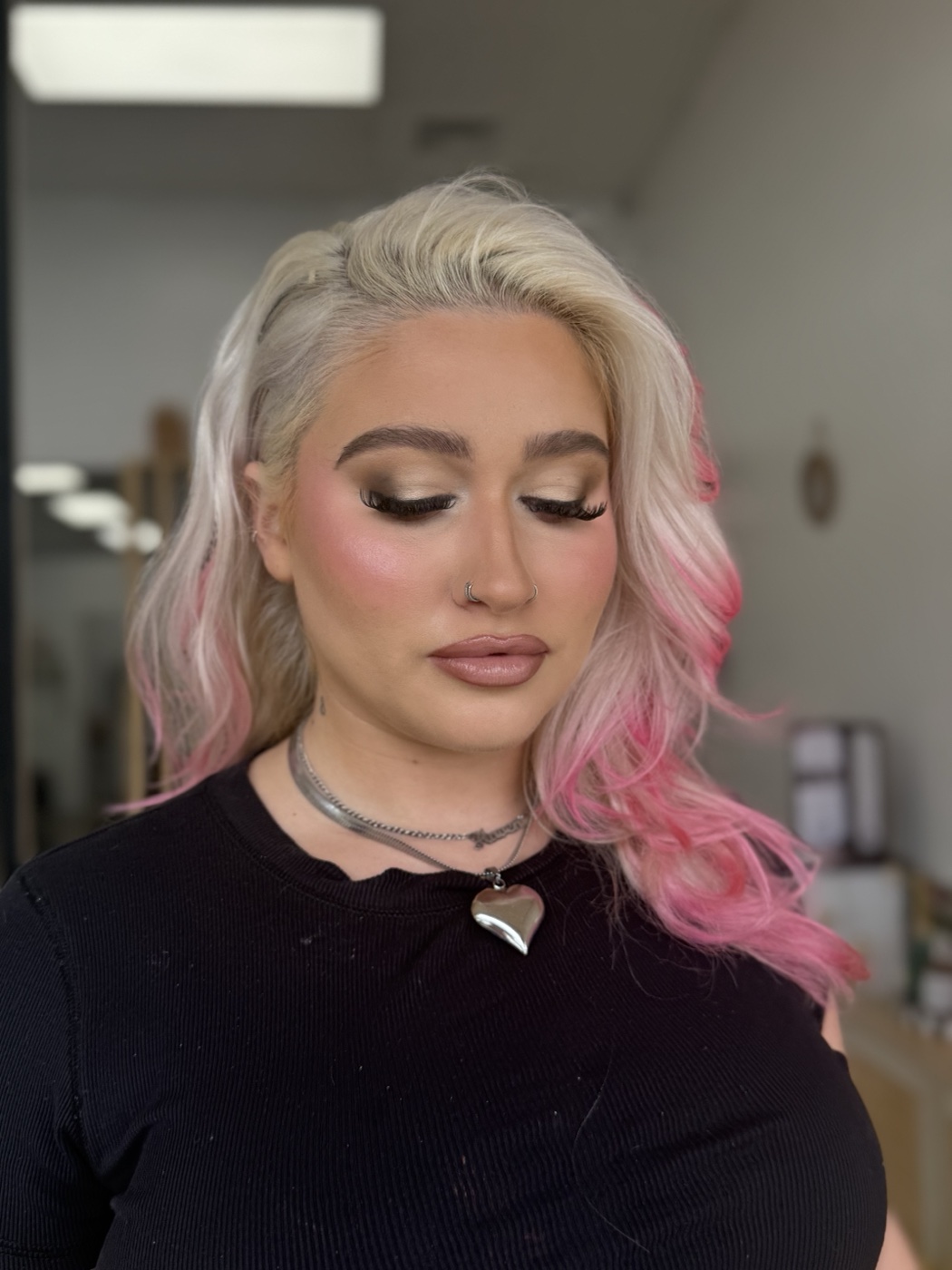 Editorial look with pink-tipped blonde waves and jeweled hearts